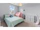 Bright bedroom featuring a bed, window, pink play tent, and a white storage unit, perfect for a room at 9639 Ravenscroft Nw Ln, Concord, NC 28027
