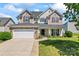 Inviting home exterior featuring a well-maintained lawn, manicured landscaping, and a welcoming front porch at 9639 Ravenscroft Nw Ln, Concord, NC 28027