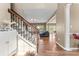 Open-concept interior view showcases hardwood floors, staircase, and seamless flow between living spaces at 9639 Ravenscroft Nw Ln, Concord, NC 28027