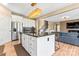 Open kitchen with stainless steel appliances, mosaic backsplash, dark countertops, and island that flows into living room at 9639 Ravenscroft Nw Ln, Concord, NC 28027