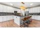 Modern kitchen with stainless steel appliances, a mosaic backsplash, dark countertops, and a center island with bar stool seating at 9639 Ravenscroft Nw Ln, Concord, NC 28027