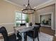 Well-lit dining area featuring a modern chandelier and table setting at 9700 Ravenscroft Nw Ln, Concord, NC 28027