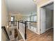A cozy hallway with a black and white railing overlooking the living area and access to rooms at 9700 Ravenscroft Nw Ln, Concord, NC 28027