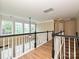 A cozy hallway with a black and white railing overlooking the living area and access to rooms at 9700 Ravenscroft Nw Ln, Concord, NC 28027