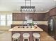 Stylish kitchen featuring a center island with seating, stainless steel appliances, and ample cabinet space at 9700 Ravenscroft Nw Ln, Concord, NC 28027