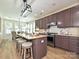 Well-designed kitchen showcasing a large island with seating, stainless steel appliances, and modern lighting at 9700 Ravenscroft Nw Ln, Concord, NC 28027