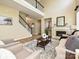 Spacious living room with a fireplace, staircase, and comfortable seating, ideal for relaxing and entertaining at 9700 Ravenscroft Nw Ln, Concord, NC 28027