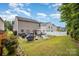 The fully fenced backyard showcases a patio, grill, and lounge seating, perfect for relaxation and outdoor gatherings at 9718 Eagle Feathers Dr, Charlotte, NC 28214