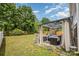 Enjoy the covered patio with outdoor seating, perfect for relaxing in this verdant backyard with shade trees at 9718 Eagle Feathers Dr, Charlotte, NC 28214