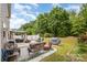 Spacious backyard with an outdoor kitchen, firepit area, and lush landscaping at 9718 Eagle Feathers Dr, Charlotte, NC 28214