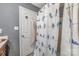 Bathroom featuring shower with modern tile, framed mirror, and white shower curtain at 9718 Eagle Feathers Dr, Charlotte, NC 28214