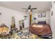 Bright bedroom with contemporary furnishings, ceiling fan, and unique mirrors at 9718 Eagle Feathers Dr, Charlotte, NC 28214