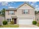 Charming two-story home with a well-maintained lawn and attached two-car garage at 9718 Eagle Feathers Dr, Charlotte, NC 28214