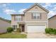 Charming two-story home with a well-maintained lawn and attached two-car garage at 9718 Eagle Feathers Dr, Charlotte, NC 28214
