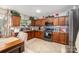 Functional kitchen featuring dark wood cabinets, modern appliances, tile backsplash, and ample counter space at 9718 Eagle Feathers Dr, Charlotte, NC 28214