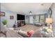 Comfortable living room featuring neutral tones, plush furnishings, a ceiling fan, and a view of the home's entryway at 9718 Eagle Feathers Dr, Charlotte, NC 28214