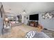 Open living room with neutral walls, carpet, modern decor, a ceiling fan, and access to other living spaces at 9718 Eagle Feathers Dr, Charlotte, NC 28214