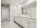 Bathroom featuring double sinks, white cabinets, and a large mirror at 9952 Manor Vista Trl, Kannapolis, NC 28027