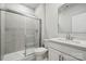 Bathroom with walk-in shower, tiled surround, glass door and modern sink at 9952 Manor Vista Trl, Kannapolis, NC 28027