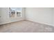 Neutral bedroom with window providing natural light and neutral carpet at 9952 Manor Vista Trl, Kannapolis, NC 28027