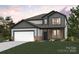 Two-story home featuring brick and siding, a two-car garage, and professionally landscaped lawn at 9952 Manor Vista Trl, Kannapolis, NC 28027