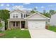 Charming two-story home with a mix of brick and gray siding, complemented by a well-manicured lawn at 9952 Manor Vista Trl, Kannapolis, NC 28027