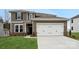 This lovely two-story home has a two car garage, well manicured landscaping, and a brick facade at 9952 Manor Vista Trl, Kannapolis, NC 28027