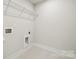 Minimalist laundry room with white walls and simple wire shelving at 9952 Manor Vista Trl, Kannapolis, NC 28027