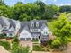 Beautiful home with a stone and white siding facade, dormer windows, a two-car garage, and mature landscaping at 1012 N Sharon Amity Rd, Charlotte, NC 28211