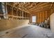 Unfinished attic with exposed wood beams and plywood subfloor at 1012 N Sharon Amity Rd, Charlotte, NC 28211