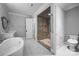 Elegant bathroom featuring a soaking tub, walk-in shower, and modern fixtures at 1012 N Sharon Amity Rd, Charlotte, NC 28211