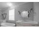 Bathroom showcases double vanities, a soaking tub, and decorative mirrors at 1012 N Sharon Amity Rd, Charlotte, NC 28211