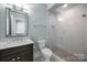 Modern bathroom featuring sleek vanity, glass shower, and contemporary fixtures at 1012 N Sharon Amity Rd, Charlotte, NC 28211