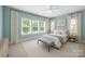 Spacious bedroom features a large bed, and large windows for a bright room at 1012 N Sharon Amity Rd, Charlotte, NC 28211