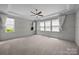 Spacious bedroom boasts decorative trim, ceiling fan, and large bright windows at 1012 N Sharon Amity Rd, Charlotte, NC 28211