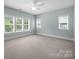 Bright bedroom with large windows offering natural light and neutral carpet and paint at 1012 N Sharon Amity Rd, Charlotte, NC 28211