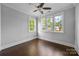 Nice bedroom featuring dark wood flooring, three large windows and ceiling fan at 1012 N Sharon Amity Rd, Charlotte, NC 28211