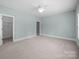 Neutral bedroom featuring a ceiling fan and adjacent doorways for easy access at 1012 N Sharon Amity Rd, Charlotte, NC 28211