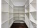 Spacious closet with custom built-in shelving and hardwood floor at 1012 N Sharon Amity Rd, Charlotte, NC 28211