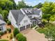 Stunning two-story home boasting stone accents, dormer windows, a two-car garage and manicured landscaping at 1012 N Sharon Amity Rd, Charlotte, NC 28211
