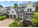 Charming two-story home with a combination of stone and white siding, dormer windows, and a two-car garage at 1012 N Sharon Amity Rd, Charlotte, NC 28211