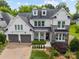 Beautiful two-story home featuring a stone and siding facade, dormer windows, and a two-car garage at 1012 N Sharon Amity Rd, Charlotte, NC 28211
