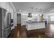 A spacious kitchen featuring an island, stainless steel appliances, and sleek white cabinets at 1012 N Sharon Amity Rd, Charlotte, NC 28211