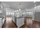 An open concept kitchen features a kitchen island with stainless steel appliances at 1012 N Sharon Amity Rd, Charlotte, NC 28211