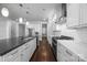 A modern kitchen featuring an island, stainless steel appliances, and sleek white cabinets at 1012 N Sharon Amity Rd, Charlotte, NC 28211