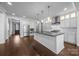 A spacious kitchen featuring an island, stainless steel appliances, and sleek white cabinets at 1012 N Sharon Amity Rd, Charlotte, NC 28211