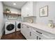 Well-organized laundry room with modern appliances, ample counter space, and stylish storage solutions at 1012 N Sharon Amity Rd, Charlotte, NC 28211