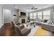 Inviting living room features a stone fireplace, hardwood floors, and a comfortable gray sofa at 1012 N Sharon Amity Rd, Charlotte, NC 28211