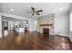 An open-concept living room adjacent to a kitchen with a fireplace at 1012 N Sharon Amity Rd, Charlotte, NC 28211