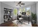 Well-lit office space with a ceiling fan, large windows, and functional work area at 1012 N Sharon Amity Rd, Charlotte, NC 28211